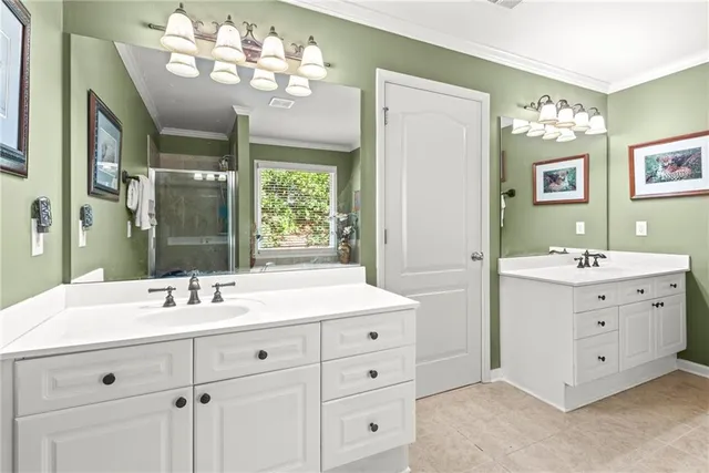 a bathroom with a double vanity sink mirror and next to a window