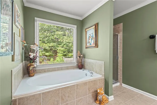 a bath tub sitting in a bathroom next to a window