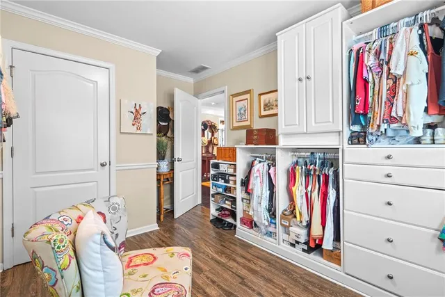 a view of walk in closet with clothes