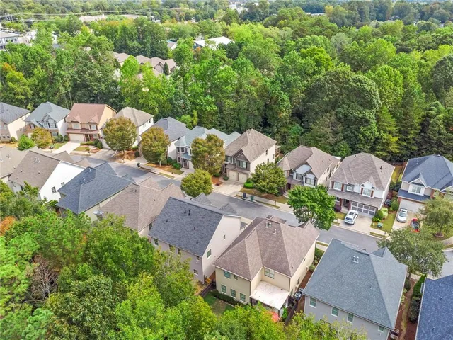 an aerial view of a house with a yard