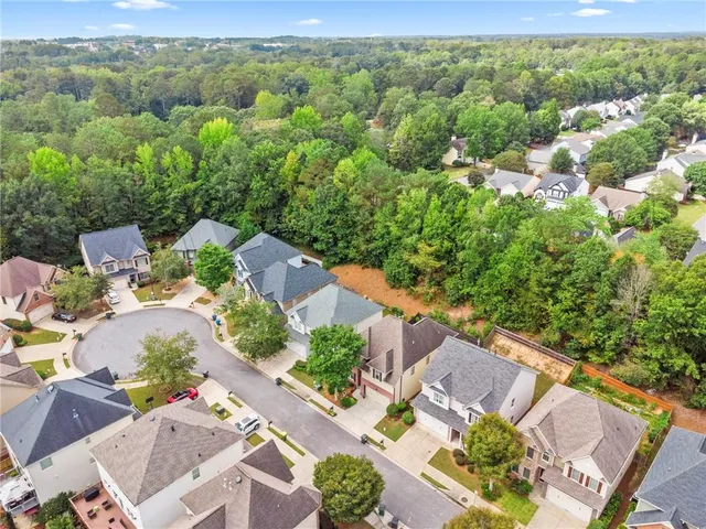 an aerial view of a house with a yard
