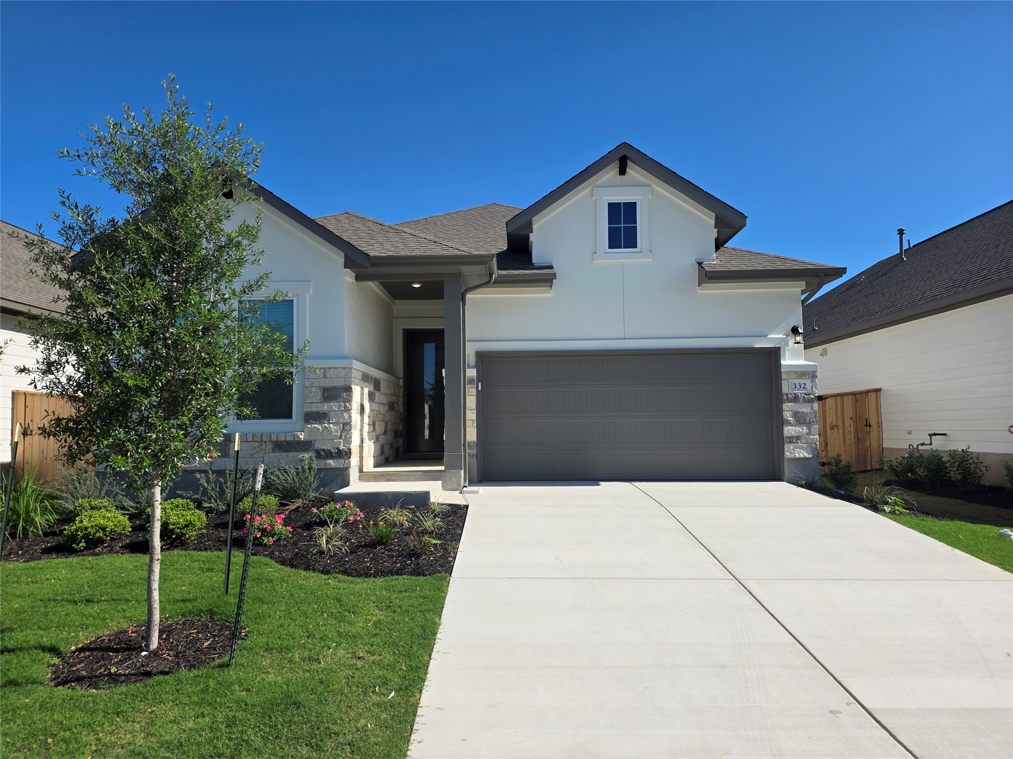 332 Marisol Bend Georgetown, TX 78626 - Photo 3 of 31 a front view of a house with a garden and trees