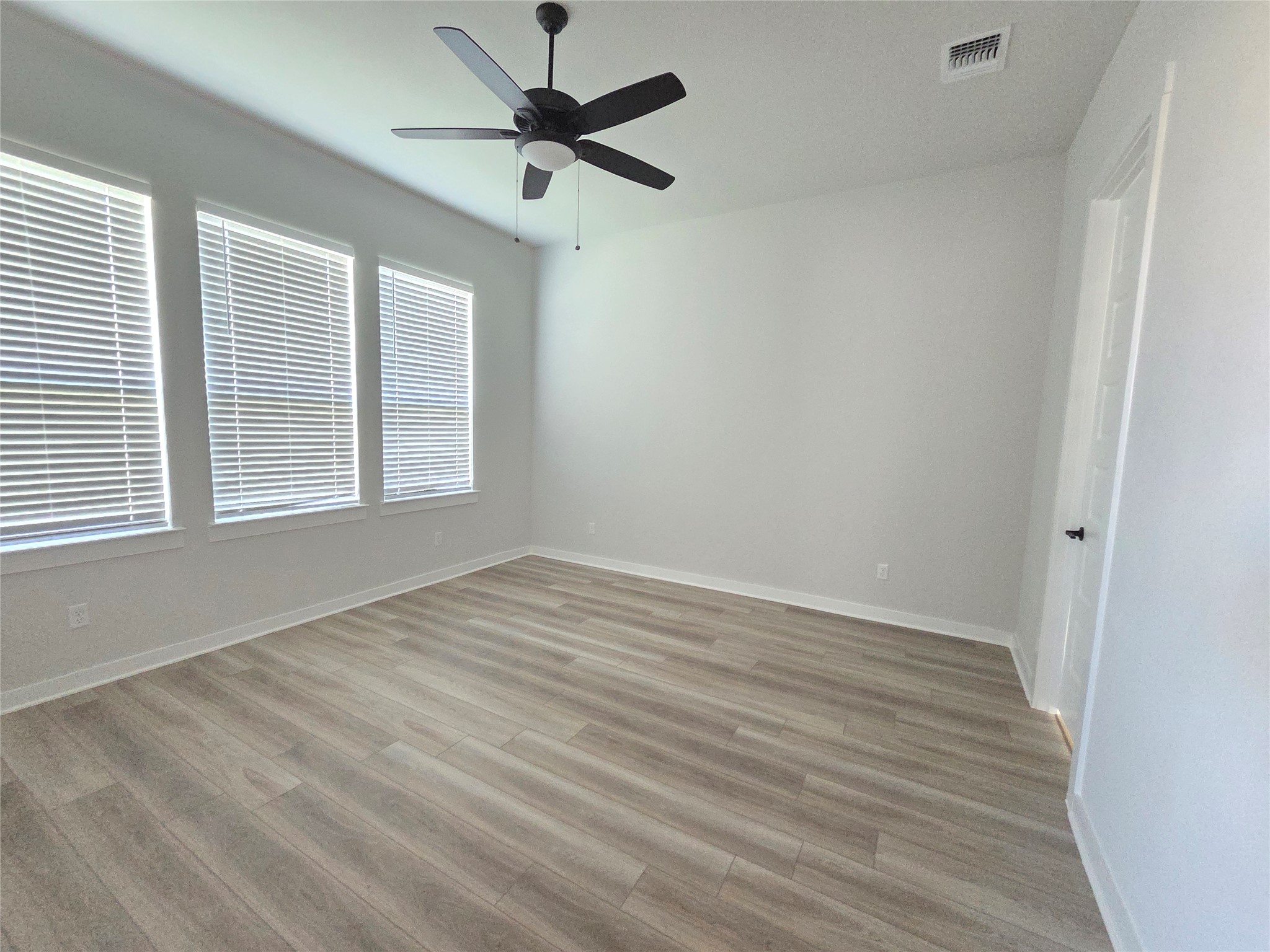 332 Marisol Bend Georgetown, TX 78626 - Photo 5 of 31 an empty room with wooden floor and windows