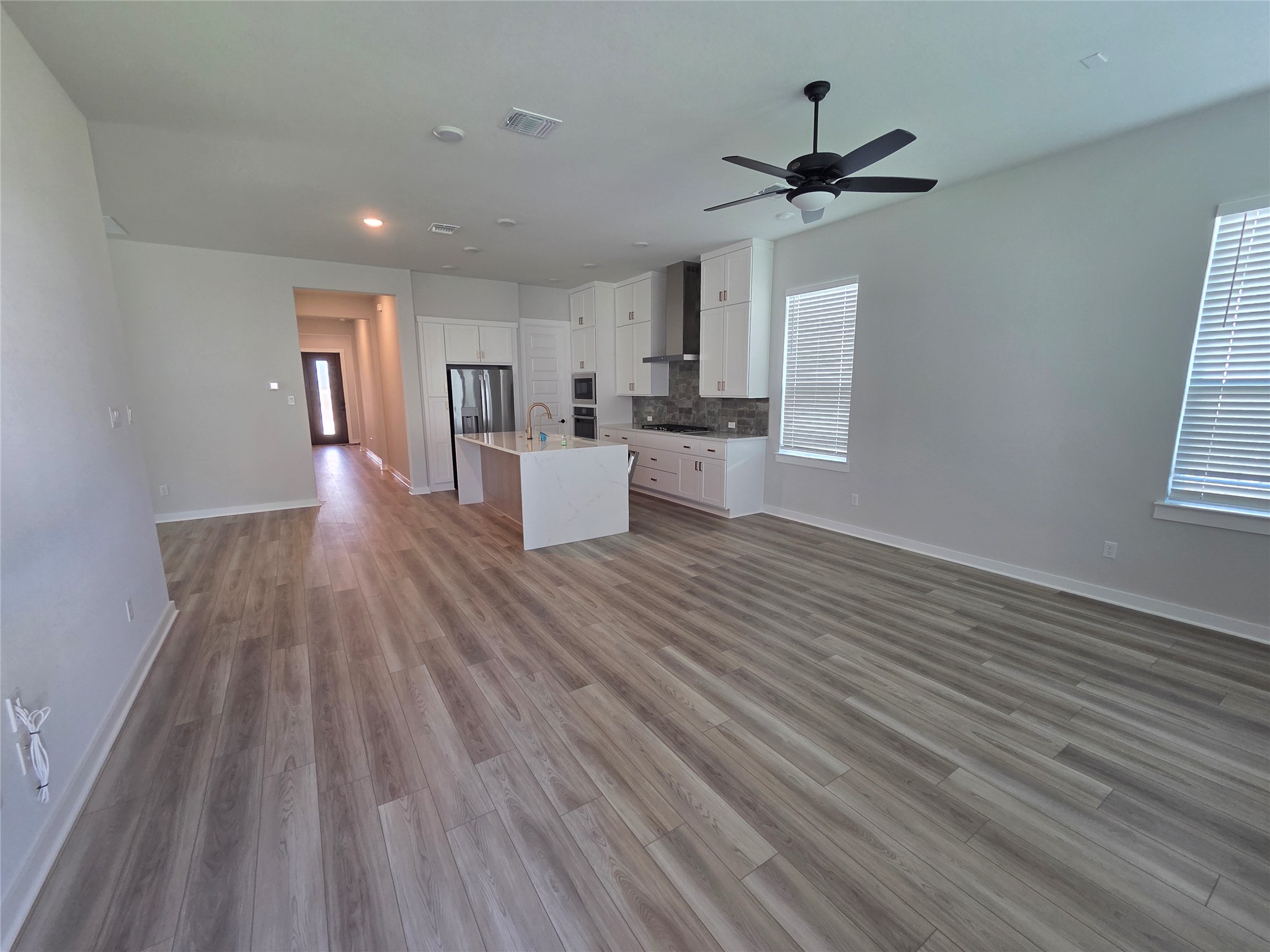 332 Marisol Bend Georgetown, TX 78626 - Photo 30 of 31 a view of a living room hardwood floor and a ceiling fan