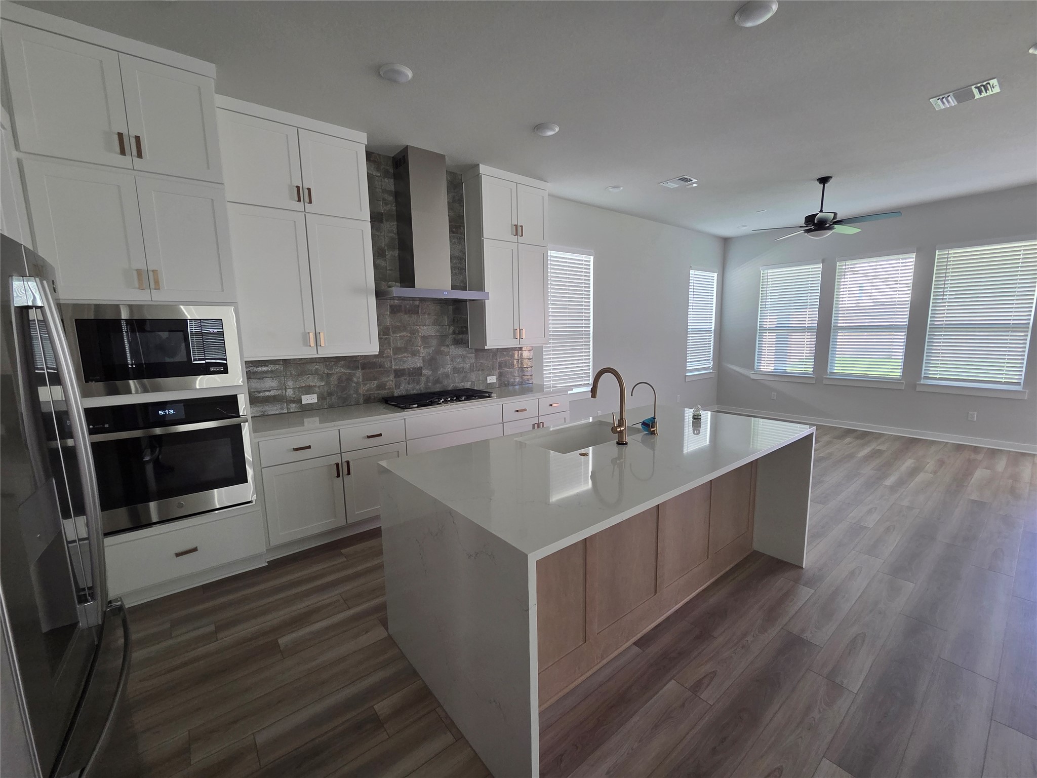 332 Marisol Bend Georgetown, TX 78626 - Photo 8 of 31 a large white kitchen with stainless steel appliances kitchen island granite countertop a sink and cabinets