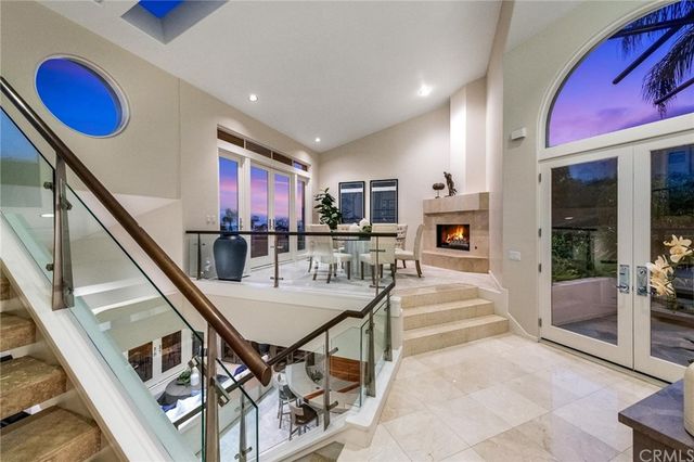 a room with stainless steel appliances kitchen island granite countertop furniture and a large window