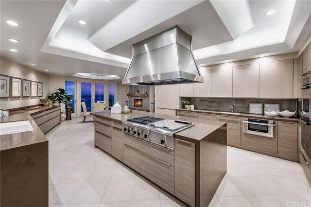 a view of a livingroom with lounge chair and a large window