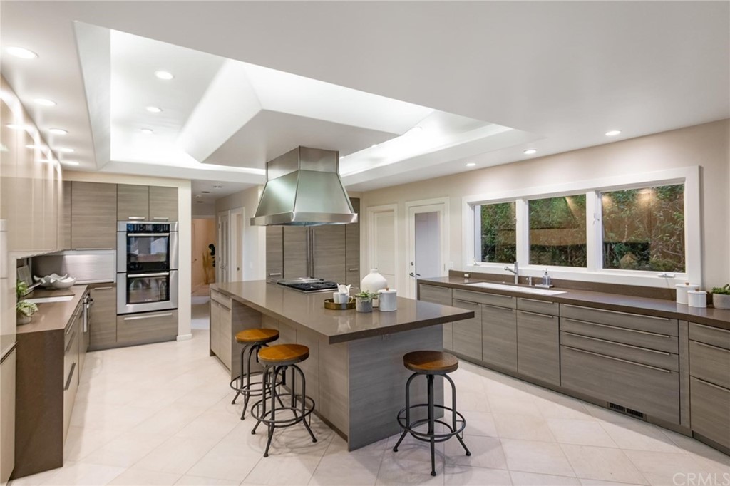 31597 Table Rock Drive Laguna Beach, CA 92651 - Photo 47 of 75 a kitchen with stainless steel appliances kitchen island granite countertop a table and chairs in it