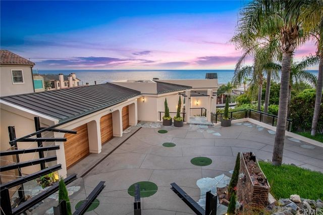 a view of a dining room with furniture and a chandelier