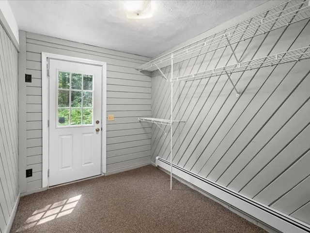 a view of a room with an empty space and a window