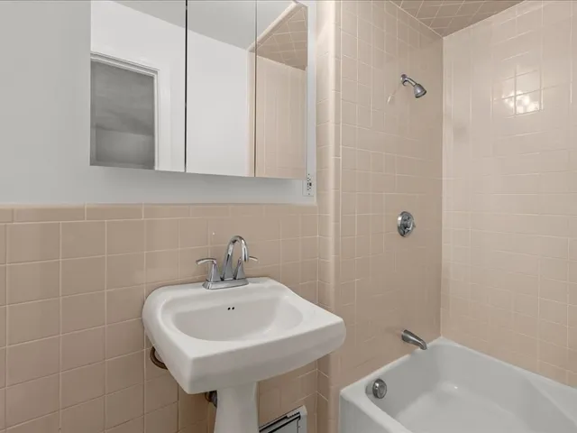 a bathroom with a sink a toilet and mirror