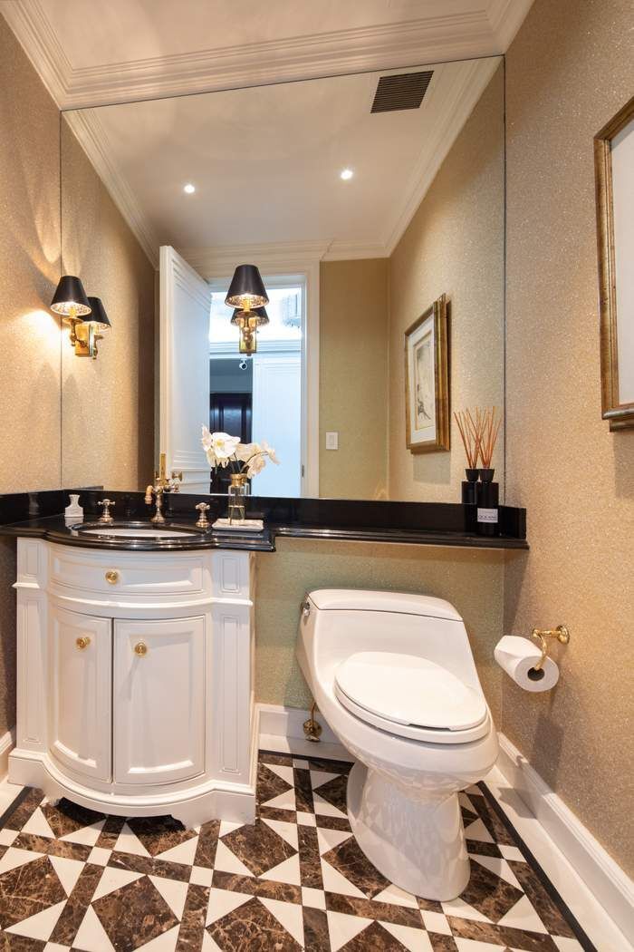 781 5th Avenue, Unit 505 Manhattan, NY 10022 - Photo 11 of 14 a bathroom with a toilet a sink and mirror