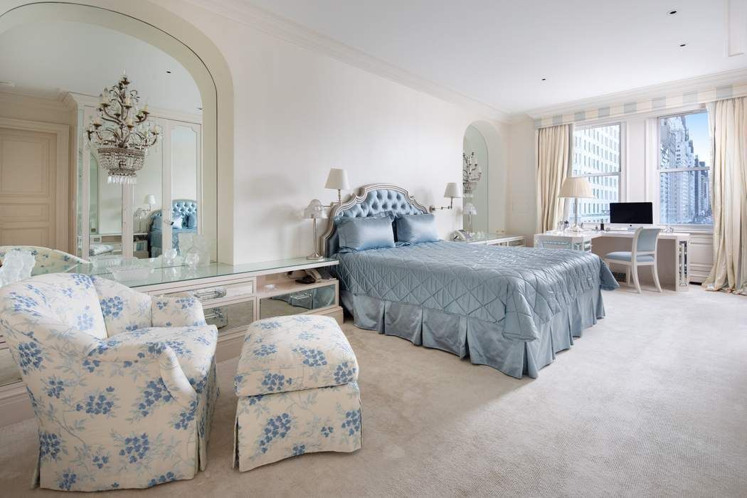 781 5th Avenue, Unit 505 Manhattan, NY 10022 - Photo 4 of 14 a spacious bedroom with two beds and large windows