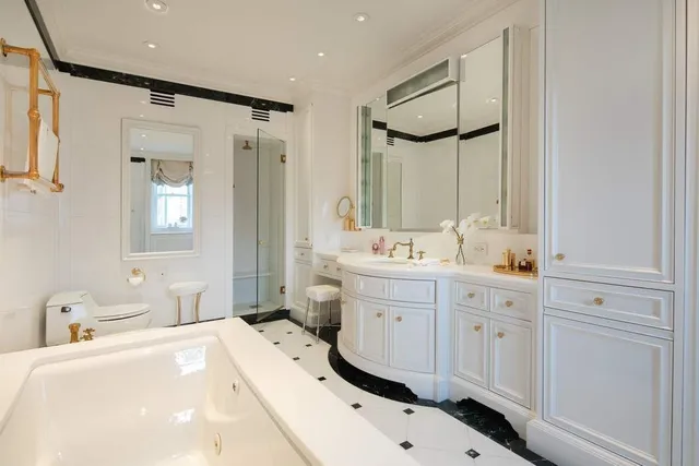 a spacious bedroom with two beds and large windows