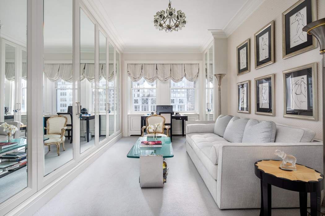 781 5th Avenue, Unit 505 Manhattan, NY 10022 - Photo 6 of 14 a living room with furniture and a large window