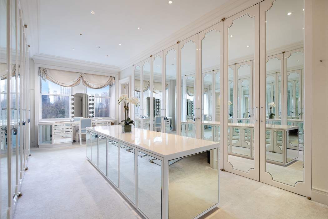 781 5th Avenue, Unit 505 Manhattan, NY 10022 - Photo 8 of 14 a large kitchen with a large window and a view of living room