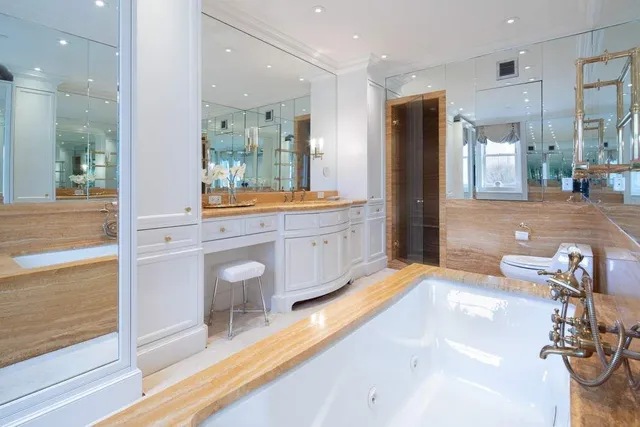 a large kitchen with a large window and a view of living room