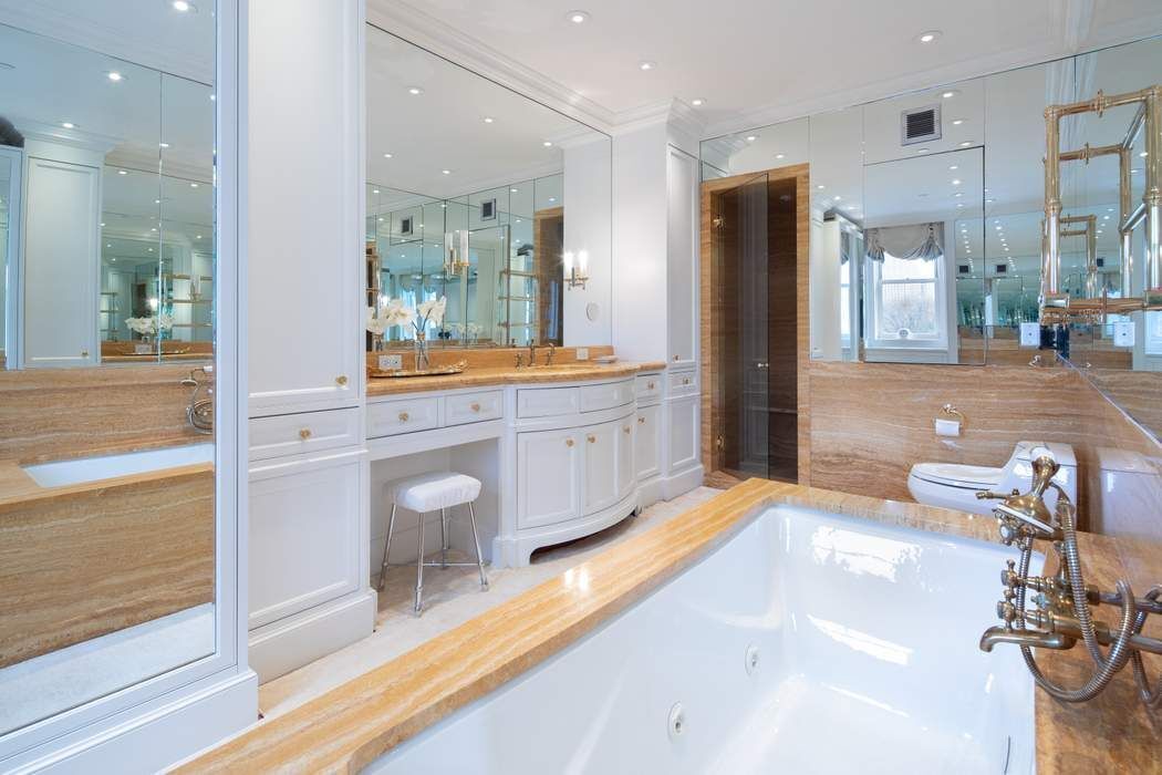 781 5th Avenue, Unit 505 Manhattan, NY 10022 - Photo 9 of 14 a bathroom with a tub sink and mirror