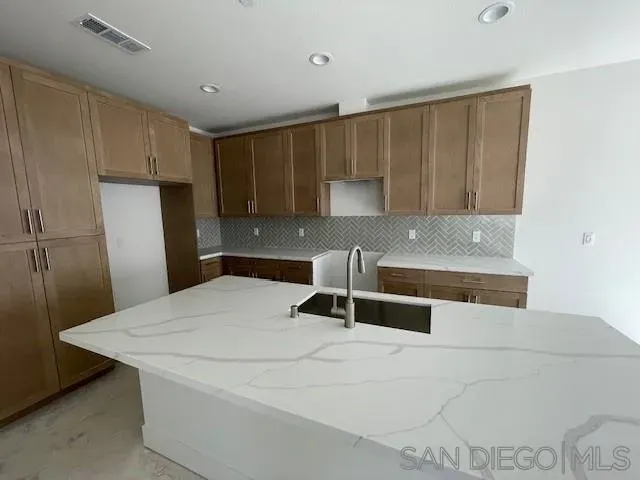 a kitchen with a sink a stove and a refrigerator