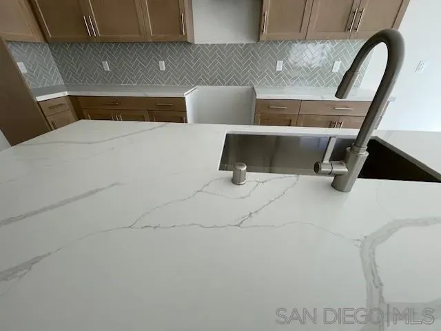 a kitchen with refrigerator and cabinets