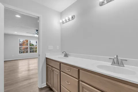 a bathroom with a sink a vanity and a large mirror