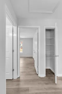 a view of a room with wooden floor & entryway