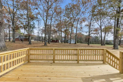 a view of a yard with wooden fence and trees