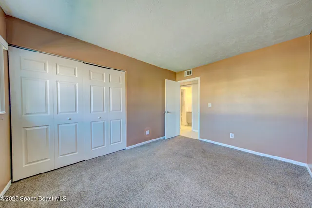 a view of an empty room and entryway