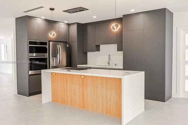 a kitchen with stainless steel appliances a refrigerator and a stove