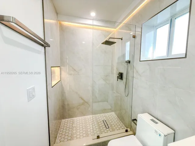 an empty room with a empty space and windows