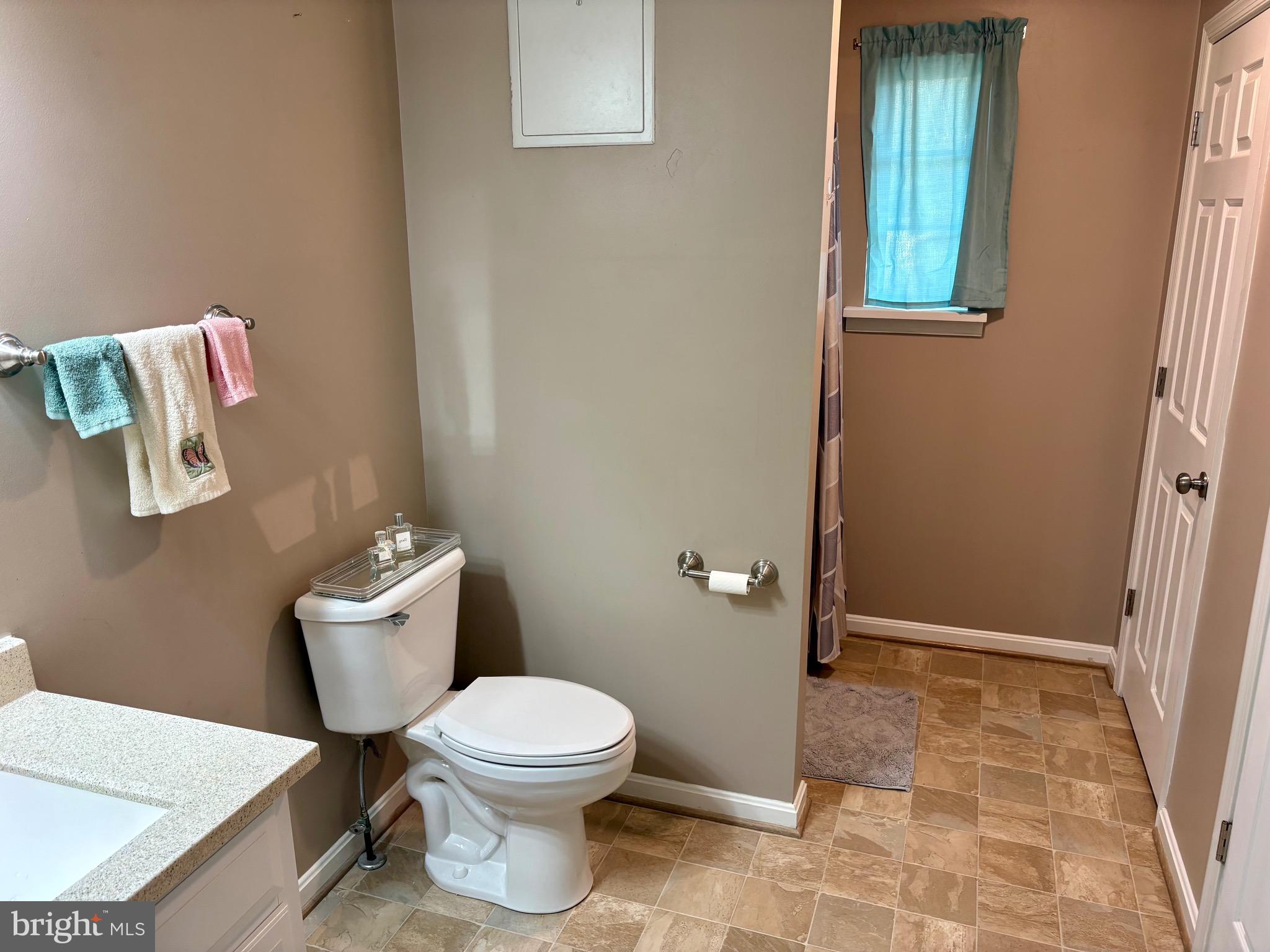 45394 Walnut Street Piney Point, MD 20674 - Photo 13 of 23 a white toilet sitting next to a bathroom sink