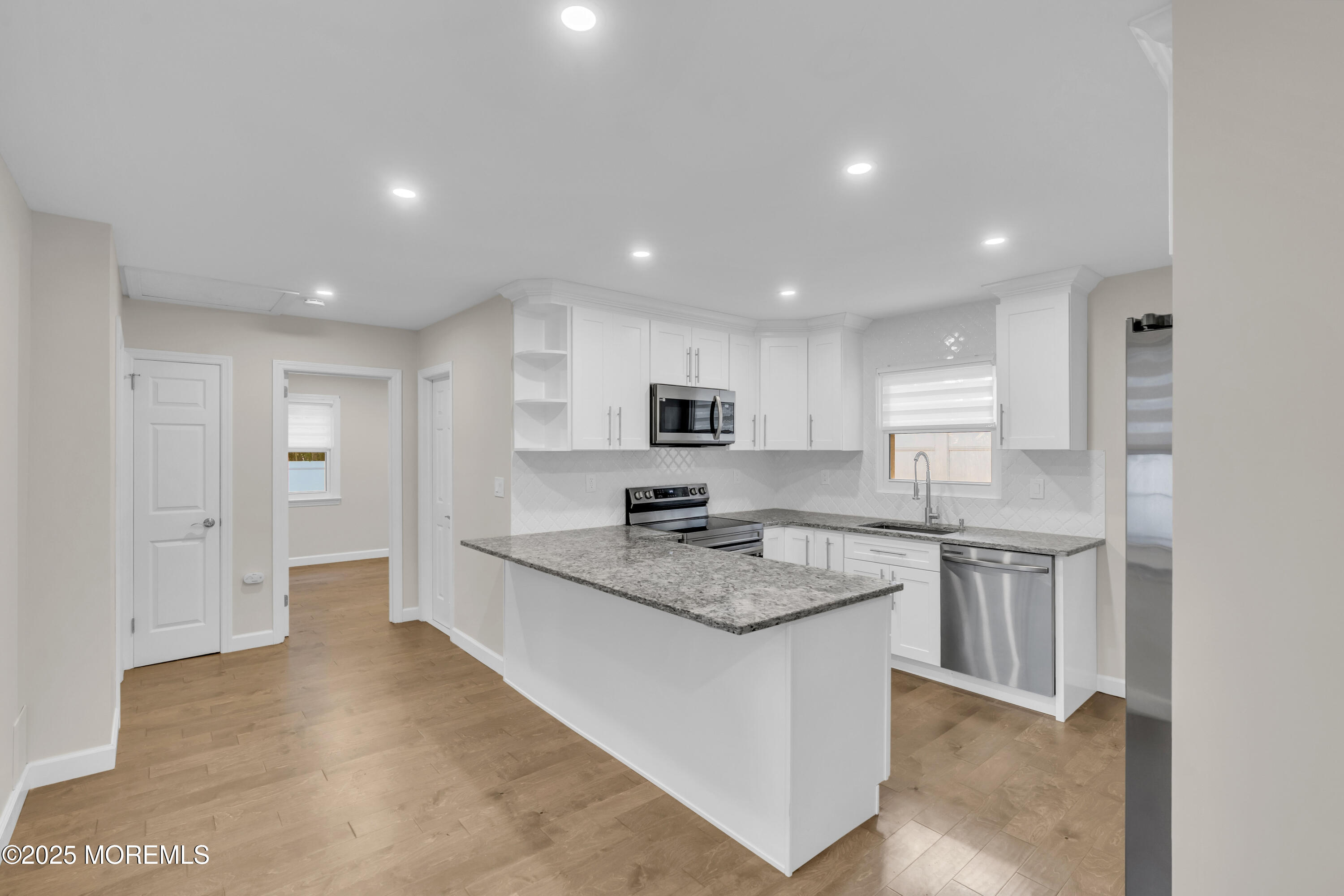 185 Elmwood Road Oakhurst, NJ 07755 - Photo 12 of 19 a kitchen with stainless steel appliances granite countertop a sink stove and refrigerator