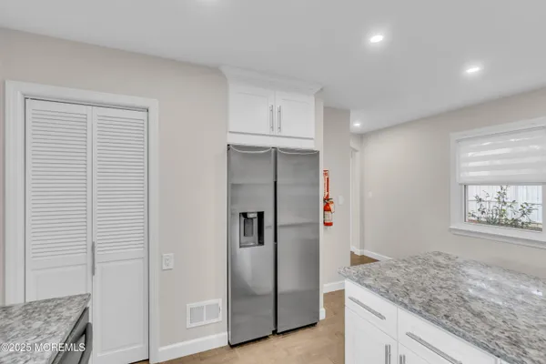 a view of a kitchen cabinets and refrigerator