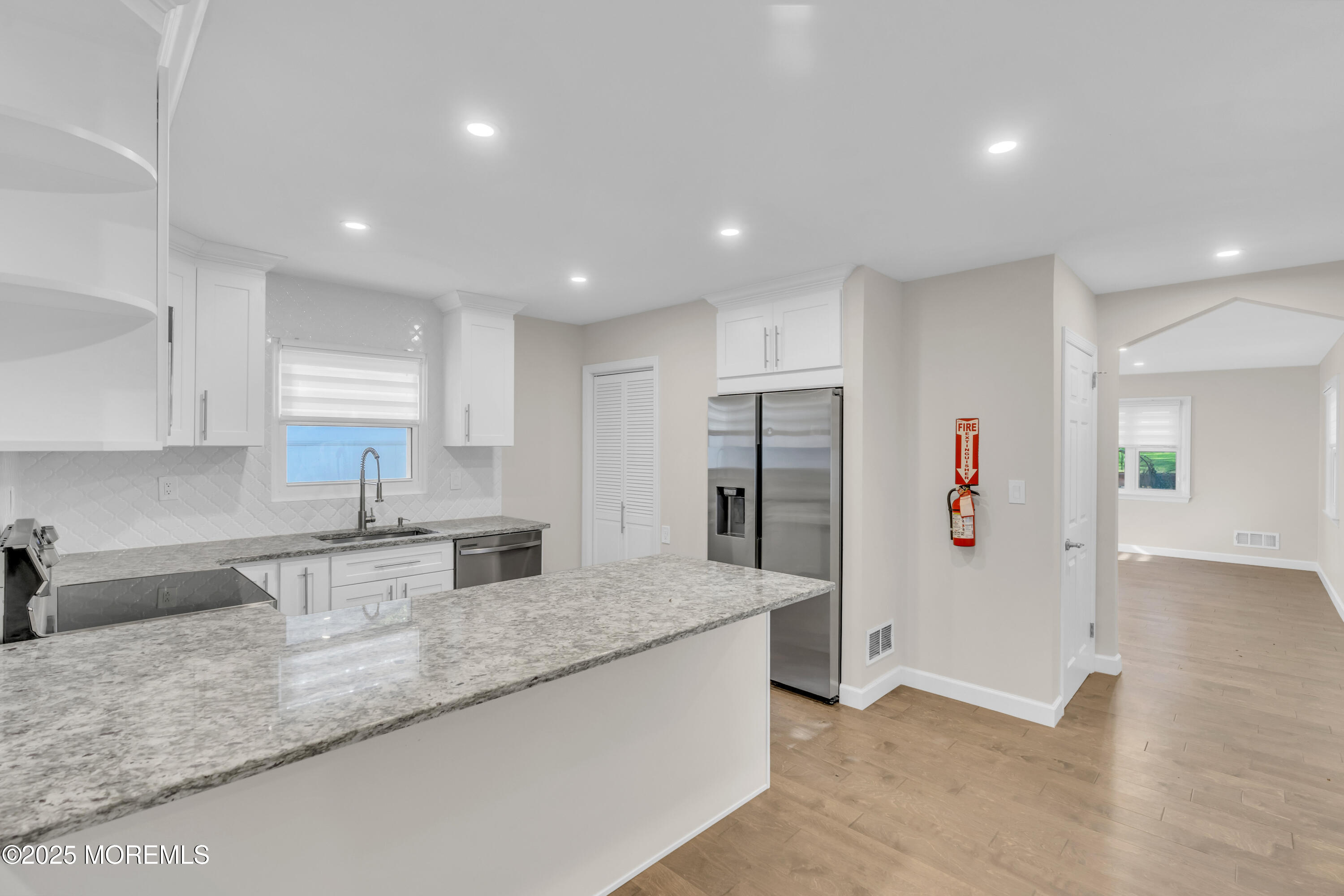 185 Elmwood Road Oakhurst, NJ 07755 - Photo 10 of 19 a kitchen with stainless steel appliances granite countertop a refrigerator and a sink