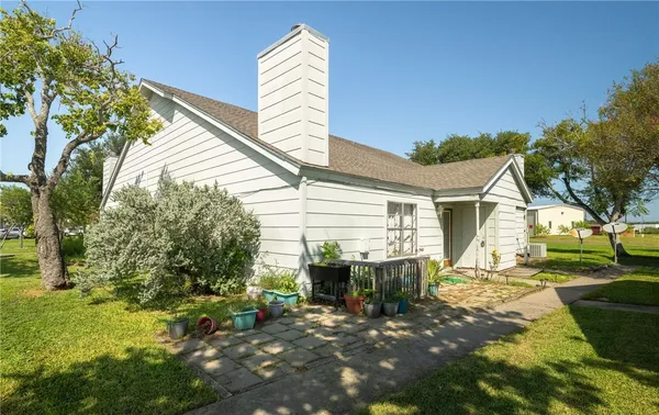 a view of a house with backyard and sitting area