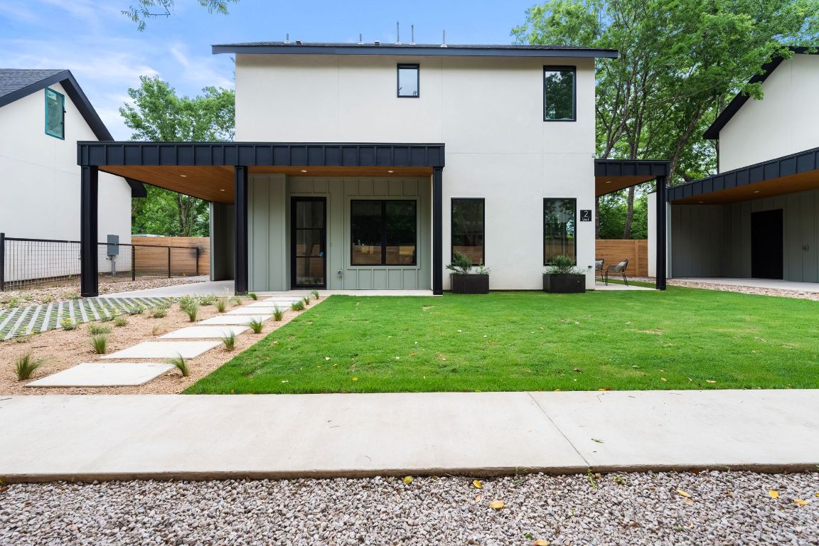 a wooden bench sitting in front of a house