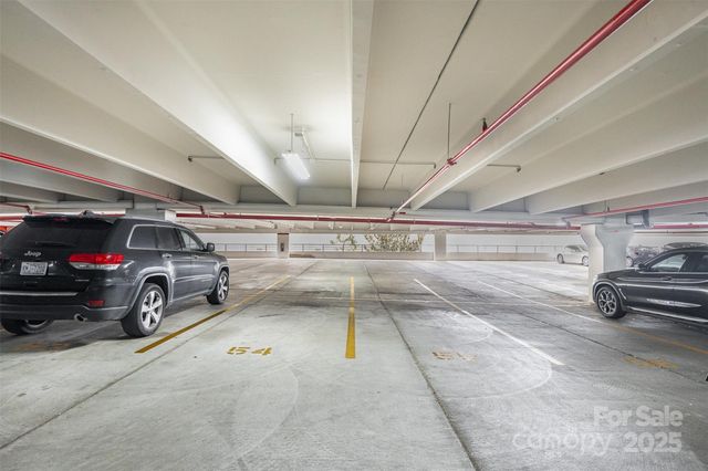 a view of parking garage with cars parked