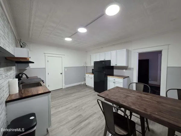 a kitchen with a table and chairs in it