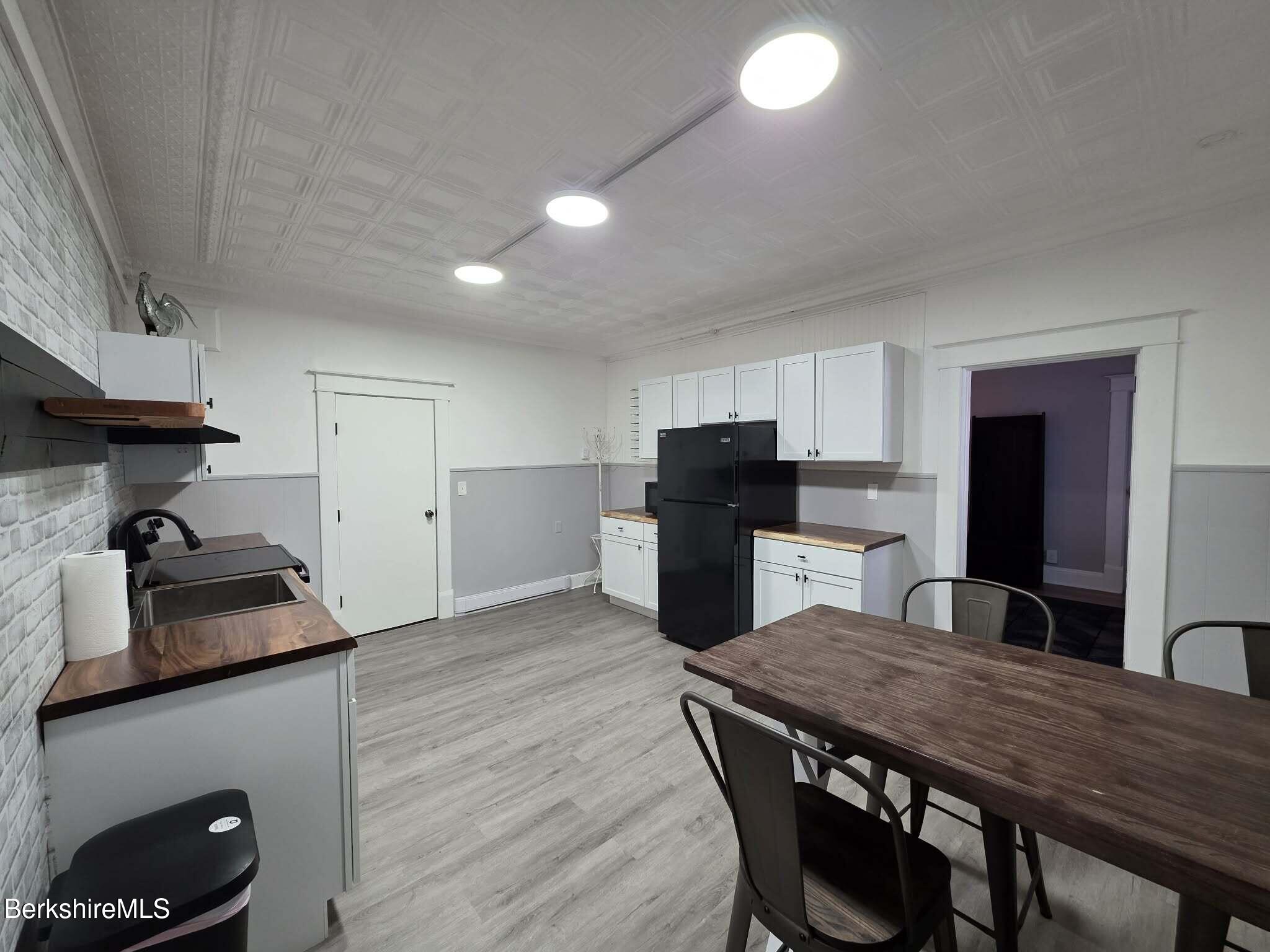 98 L Summer Street Adams, MA 01220 - Photo 2 of 17 a kitchen with a table and chairs in it