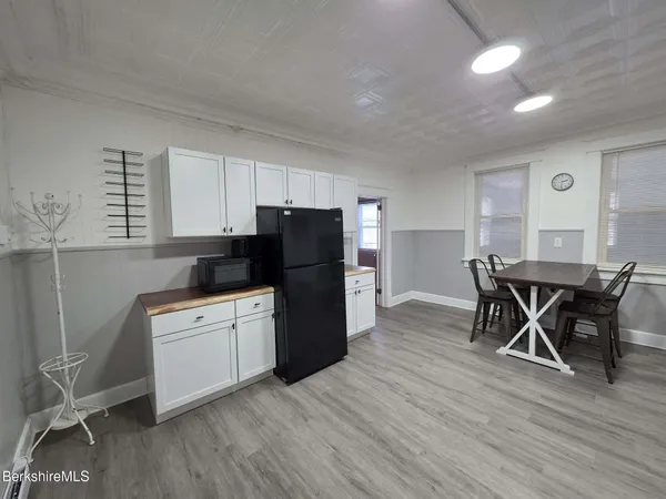 a kitchen with a wooden table and chairs