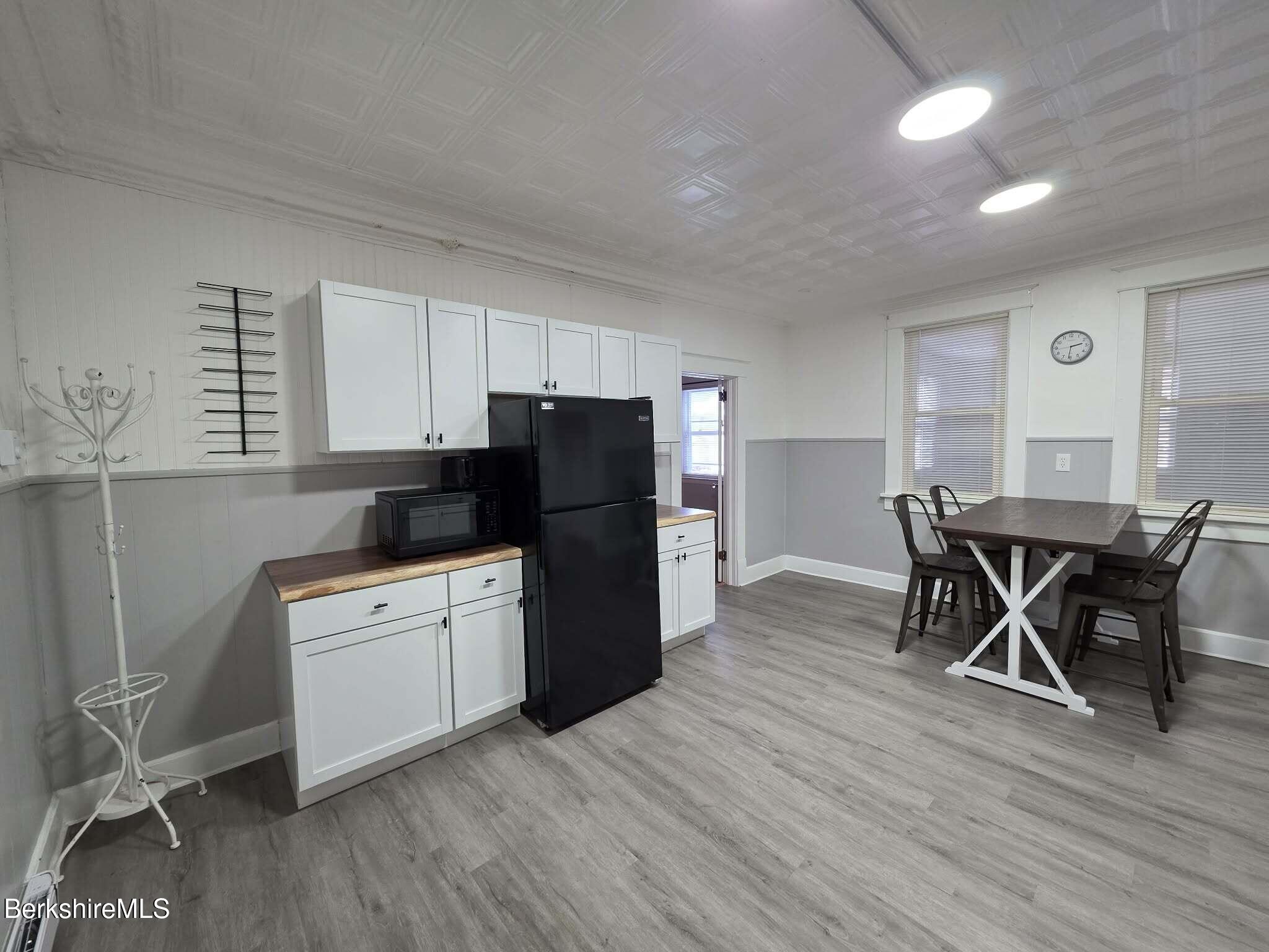98 L Summer Street Adams, MA 01220 - Photo 3 of 17 a kitchen with a wooden table and chairs