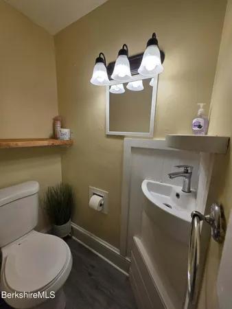 a bathroom with a toilet sink and mirror