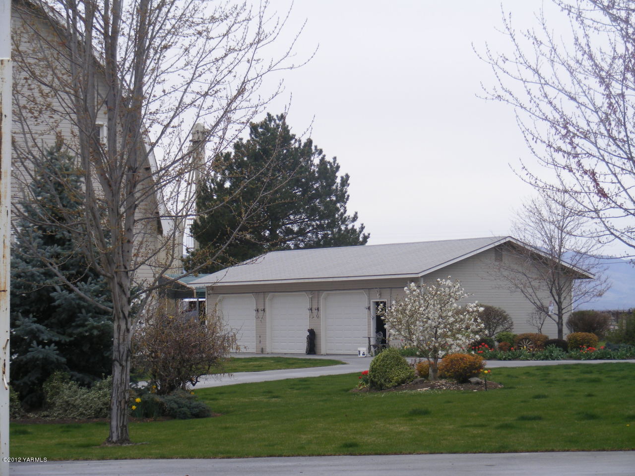 5930 Lateral B Road Wapato, WA 98951 - Photo 4 of 4 a front view of house with garden and trees
