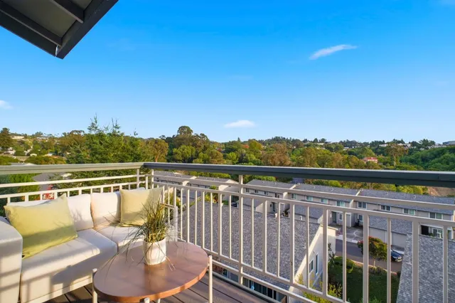 a bedroom with a balcony a bed and a walk in closet