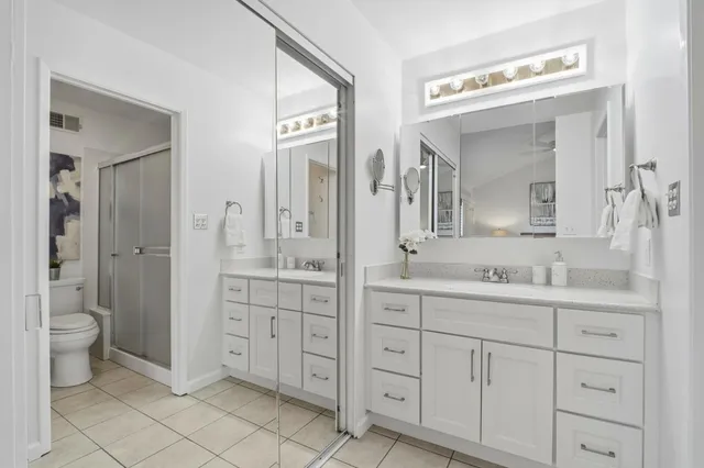 a bedroom with a bed and a potted plant