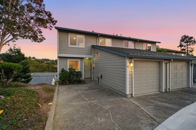 a view of a house with a backyard