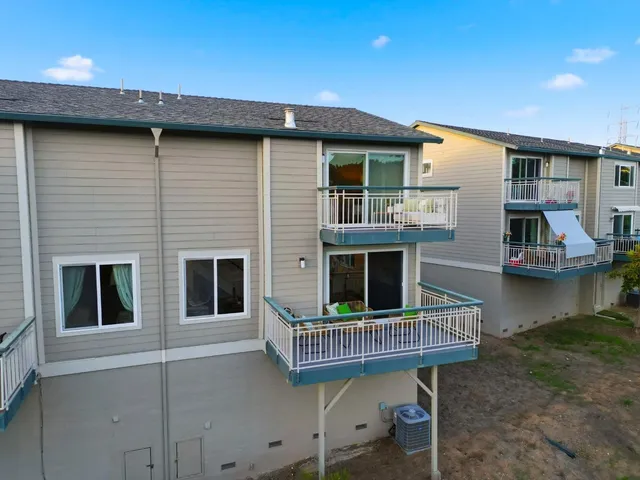 a balcony with furniture and a potted plant