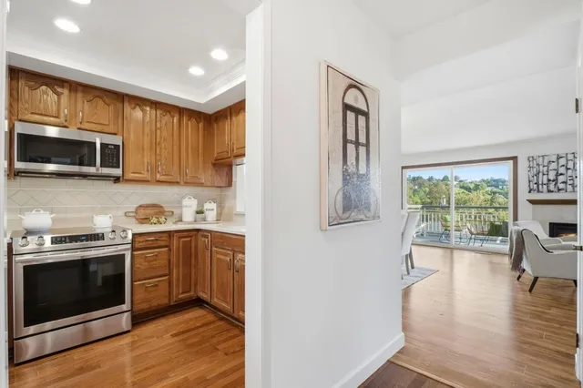 a kitchen with stainless steel appliances granite countertop a stove a sink and a microwave