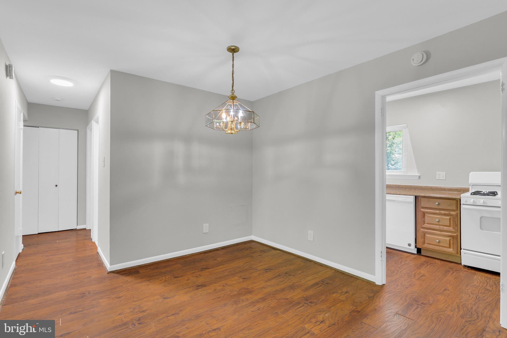 11620 Vantage Hill Road, Unit 22B Reston, VA 20190 - Photo 9 of 24 a view of empty room with wooden floor and kitchen view