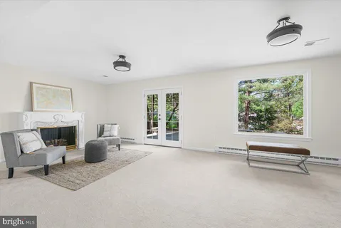 a bedroom with furniture a window and a wooden floor